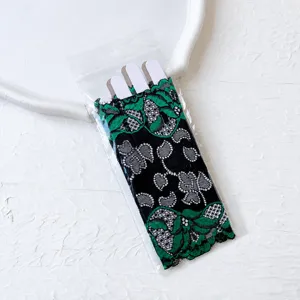 Detailed view of women half-finger contrast color lace gloves, elegant floral design for summer.