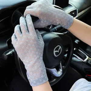 Women summer lace sun protection gloves detail view showing elegant floral pattern for driving.