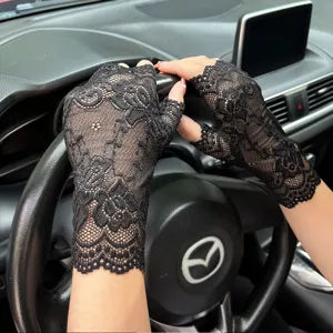 Black lace fingerless gloves detail showcasing delicate floral pattern and breathable fabric.