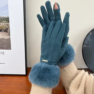 Detail view of winter warm women touchscreen gloves with plush fur cuffs in deep teal color.
