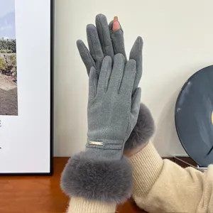 Closeup of grey thermal fleece lined gloves with plush cuff and metal accent detail.