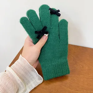 Green knit winter gloves for women with black bow detail, warm wool touchscreen five finger.
