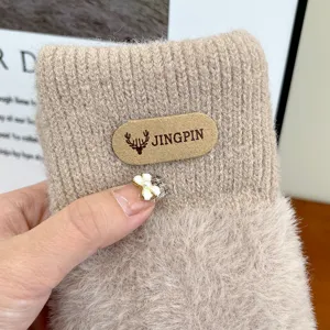 Thickened plush knit winter mittens close-up, soft faux mink wool detail showing warm texture.