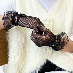 Black lace fishnet gloves with delicate ruffle cuffs and cute bows for elegant style detail.