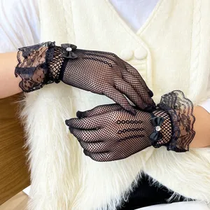 Black lace fishnet gloves with elegant bow and ruffled wrist, perfect for summer sun protection.