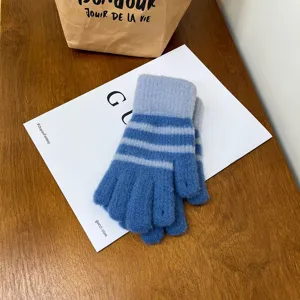 Women winter warm knit gloves, stylish blue striped touch screen half finger design for cold weather.