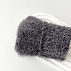 Dark grey knitted winter warm glove detail view showing soft woolen texture and quality