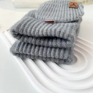 Close-up of grey knit convertible half-finger gloves with cozy woolen texture and flip mittens.
