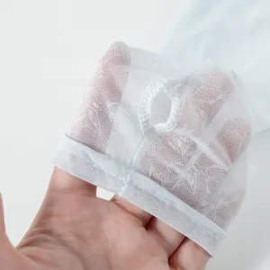 Close-up detail of summer breathable lace sun protection sleeve with convenient finger hole.