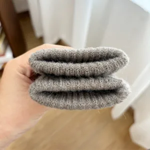 Close-up detail of thick knitted wool glove cuff, showing soft texture and cozy winter warmth.