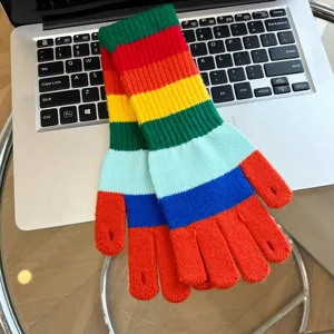 Detailed view of colorful rainbow striped fingerless knit gloves for women winter warmth.