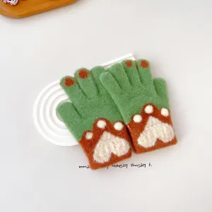 Cute children knitted warm winter gloves with lovely cat paw jacquard pattern detail view