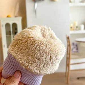 Close-up detail of winter plush fleece lined glove with cozy purple ribbed knit cuff design.