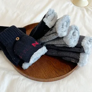 Close-up of winter fleece-lined knitted convertible half-finger gloves in dark colors.