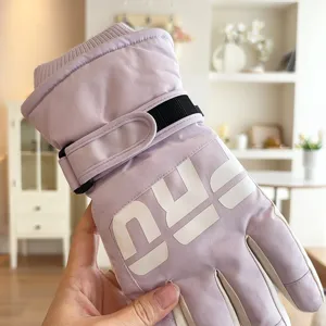 Close-up detail of winter thermal ski gloves featuring soft fleece lining and adjustable strap.