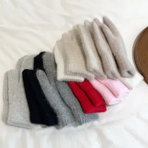 Close up view of soft fuzzy winter knit mittens in multiple cozy colors, warm fleece lined.