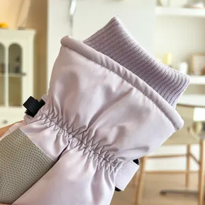 Detail shot of windproof winter ski gloves with knitted cuff and warm fleece lining.