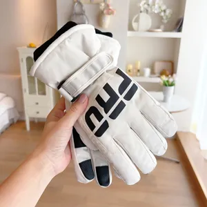 Detailed view of white winter ski gloves with thick plush lining and palm for sports.