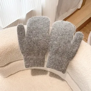 Detailed close-up view of cozy grey plush winter mittens, fluffy warm fabric texture design.
