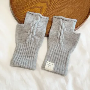 Grey cable knit fingerless gloves for women, warm winter hand warmer with cute label.