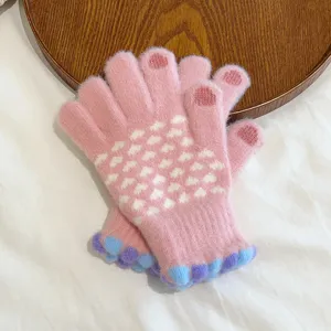 Women's pink knit winter gloves with cute heart pattern, touchscreen fingers and warm plush lining.