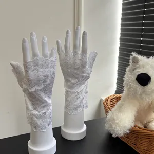 White lace fingerless gloves detail view, breathable floral mesh design for summer dancing.