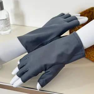 Detail view of dark grey half finger sun protection gloves, showing breathable elastic fabric design.