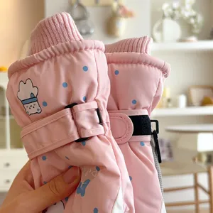 Cute pink polka dot ski gloves detail shot, soft plush lining, windproof outdoor design.