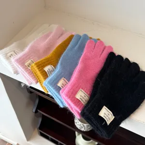 Detailed view of women's thick winter fuzzy knit fingerless gloves in multiple colors.