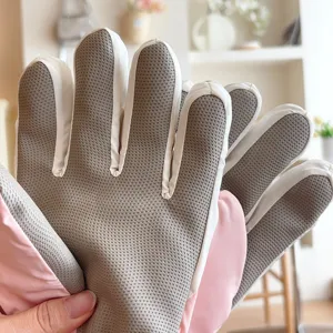 Detail view of windproof ski gloves with anti-slip textured palm and fleece lining.
