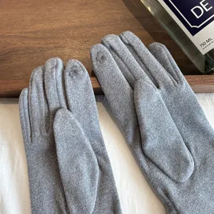 Women's grey thermal knit gloves featuring touch screen fingertips, cozy winter wear for outdoor.