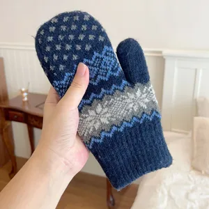 Close-up view of the cozy knitted winter mitten with classic snowflake pattern.