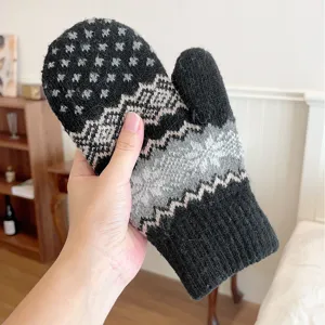 Detailed view of winter thick warm knitted mitten glove with classic snowflake pattern design