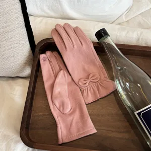Pink thermal fleece gloves detail view featuring a cute bow and delicate embroidery.