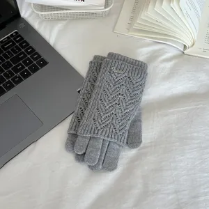 Grey knitted hollow touchscreen gloves detail view, stylish winter warm five-finger gloves.
