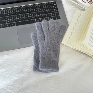 Close-up detail view of grey fluffy winter gloves, soft rabbit hair material, warm cozy texture.