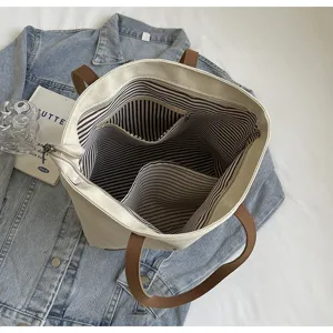 Casual canvas tote bag for women large capacity shoulder handbag with zipper and striped lining.