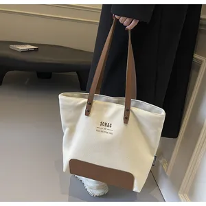 Chic canvas tote bag for women, large capacity shoulder handbag with stylish brown leather patch.