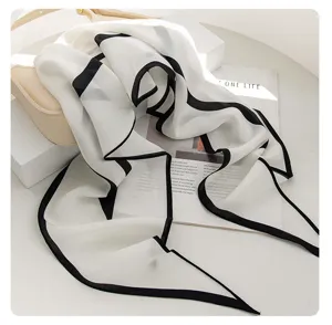 Mulberry silk scarf detail shot, elegant white with black border design for women.