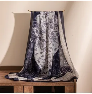 Close-up detail of a blue satin paisley floral printed decorative women scarf for all seasons.