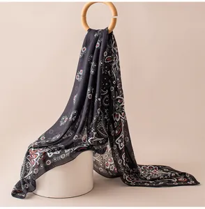 Detailed view of the dark floral printed silk scarf, elegant paisley design for all seasons.