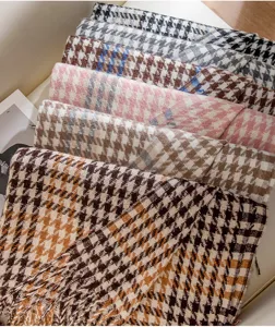 Detailed view of cozy houndstooth patterned winter scarves with soft tassels, multi-color.