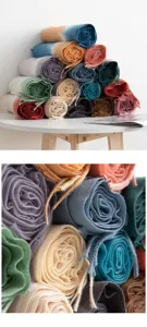 Detailed view of rolled autumn winter imitation cashmere gradient scarves with tassels.