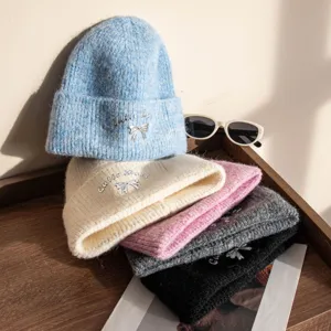 Cozy winter knitted beanie hat with cute bow embroidery, soft warm pull-on cap for women chic.