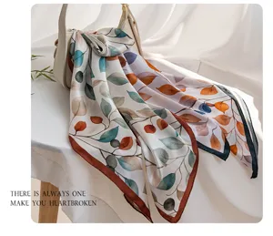 Detailed view of women's double-sided botanical leaf print silk scarf shawl elegant drape.