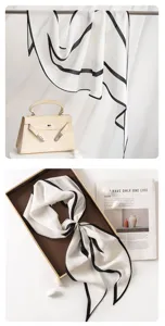 Detail view of mulberry silk scarf featuring elegant black border in lifestyle prop setup.
