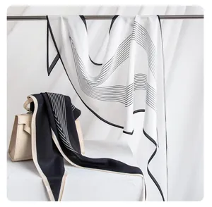 Detail view of luxury mulberry silk double-sided printed scarf with elegant black and white stripes.