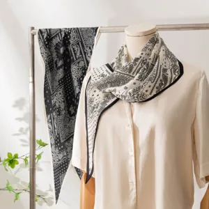 Elegant mulberry silk scarf featuring a classic paisley pattern in black and white, perfect for women.