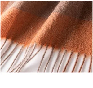 Close-up view of the warm autumn winter plaid scarf showing soft texture and tassels.