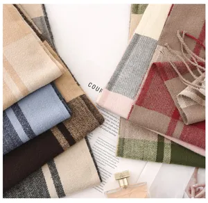 Detailed view of soft warm cashmere-feel plaid scarf, stylish winter shawl and neck warmer.